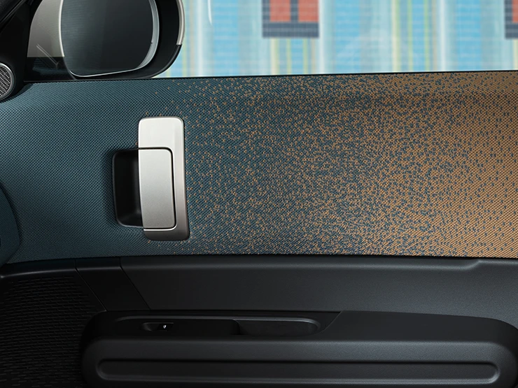 Close view of the interior design of the all-electric MINI Countryman with focus on the door and dashboard.